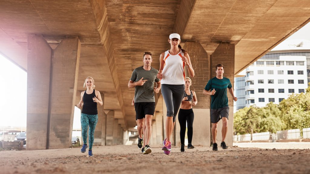 Happy people running in a group.