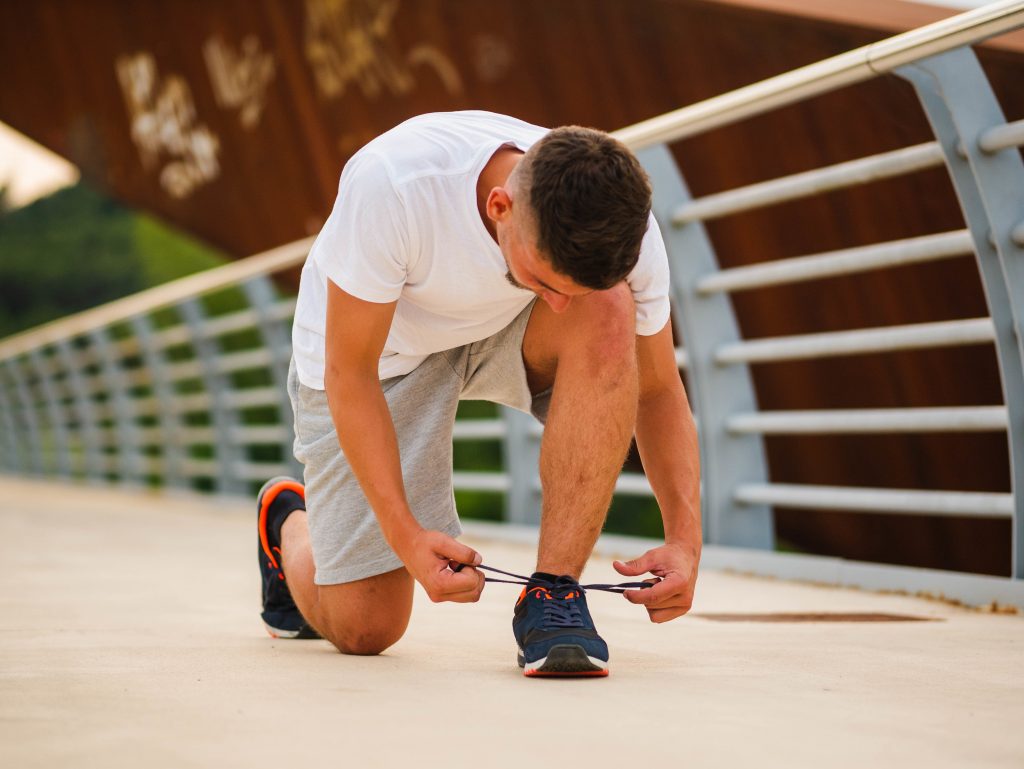 A man ties his shoelaces.