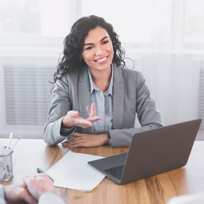 Beautiful latina travel agent is working with clients