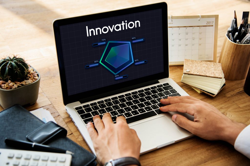 Alt: A sign saying “Innovation” on  laptop screen.